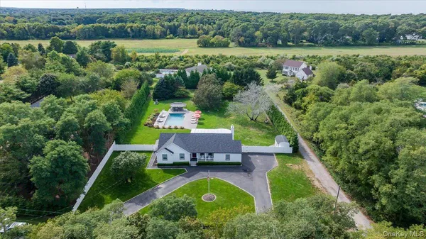 an aerial view of a house with pool outdoor seating and yard