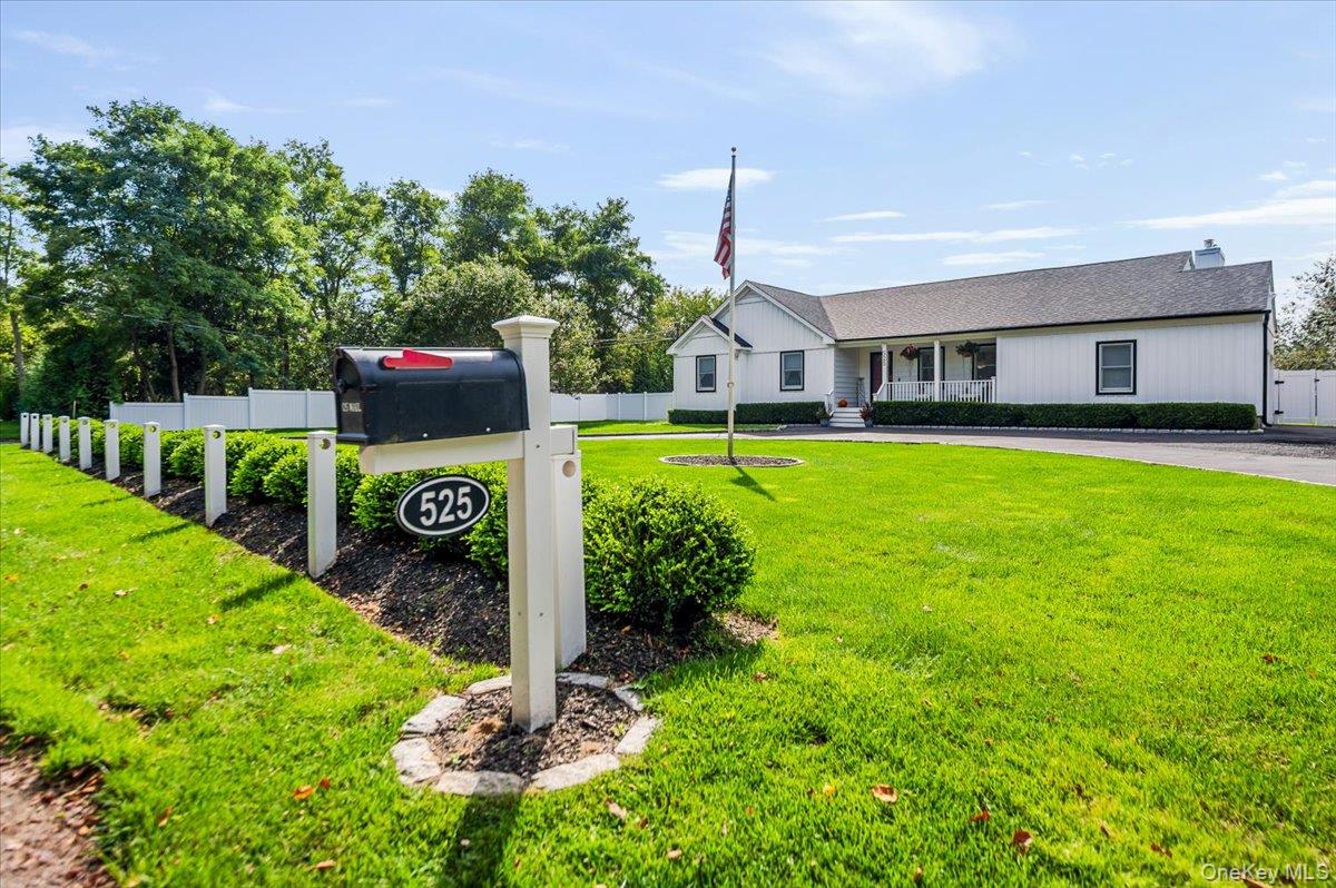 525 Rocky Point Road East Marion, NY 11939 - Photo 43 of 48 a front view of a house with garden