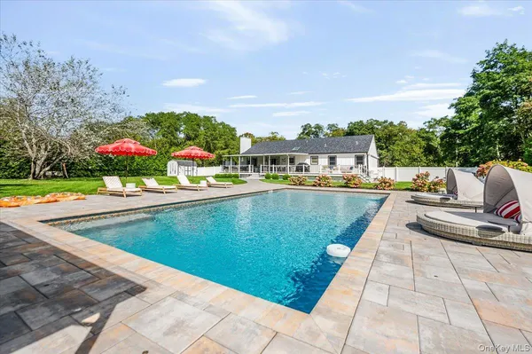 a view of a swimming pool with a lounge chairs