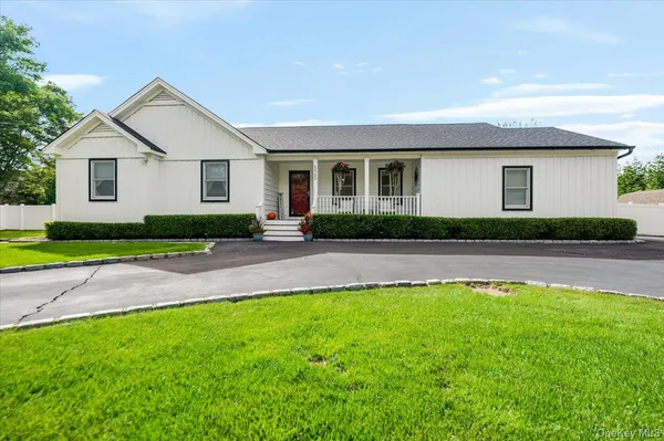 a front view of house with yard and green space