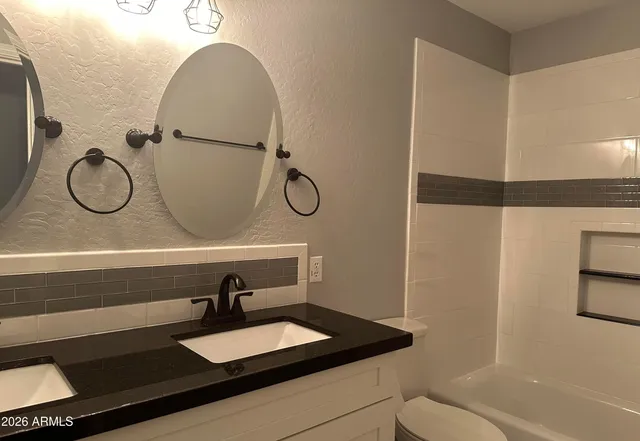 an empty room with a window and fan