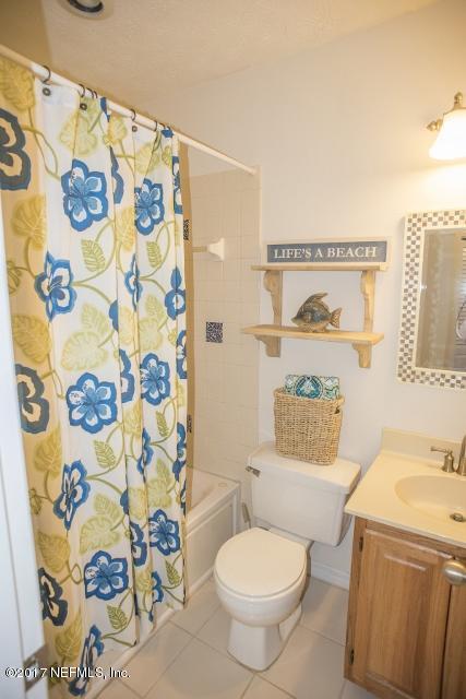 275 Jellison Road St. Augustine, FL 32080 - Photo 21 of 37 a white toilet sitting next to a sink with a curtain