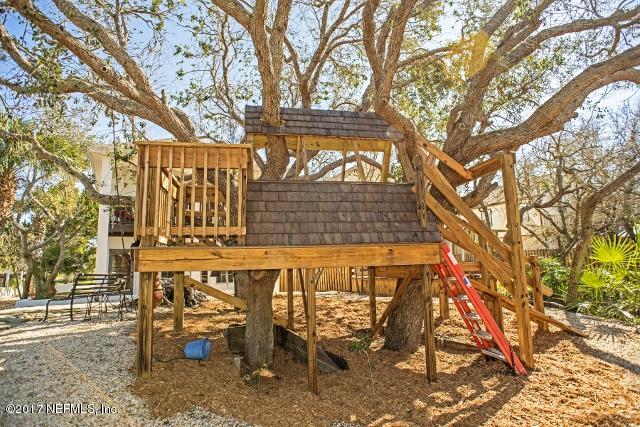 275 Jellison Road St. Augustine, FL 32080 - Photo 36 of 37 a view of a patio with table and chairs with wooden fence and large trees