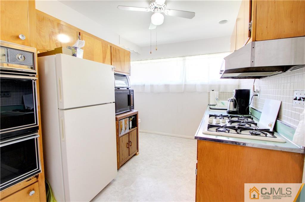 5 Purdue Road Old Bridge, NJ 08859 - Photo 3 of 25 a kitchen with a refrigerator and a stove