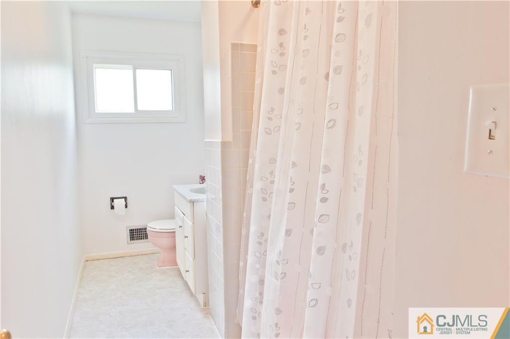 5 Purdue Road Old Bridge, NJ 08859 - Photo 5 of 25 a bathroom with a sink a toilet and a window