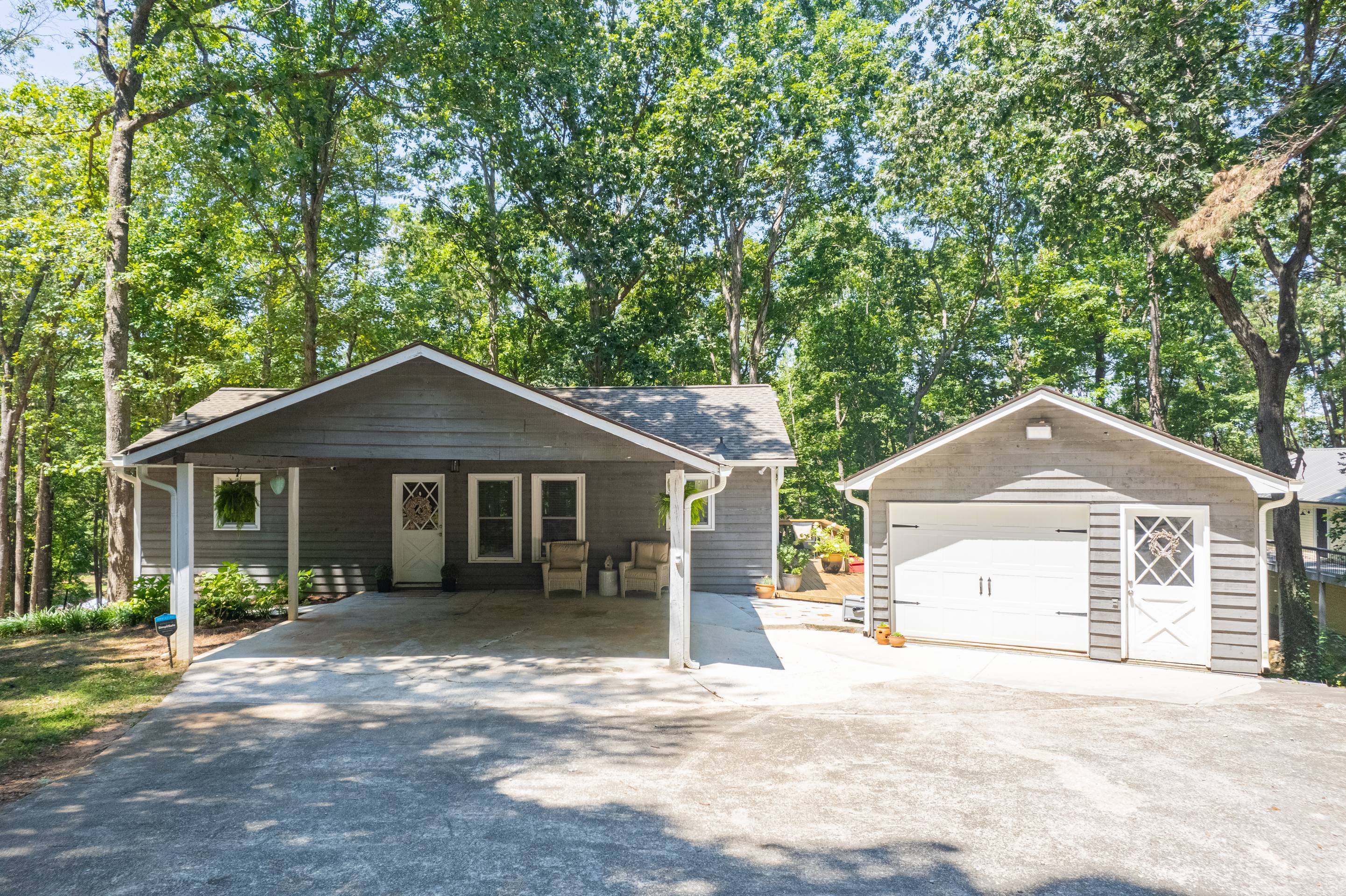 396 Cardinal Lane Toccoa, GA 30577 - Photo 2 of 103 a front view of a house with a garden and trees