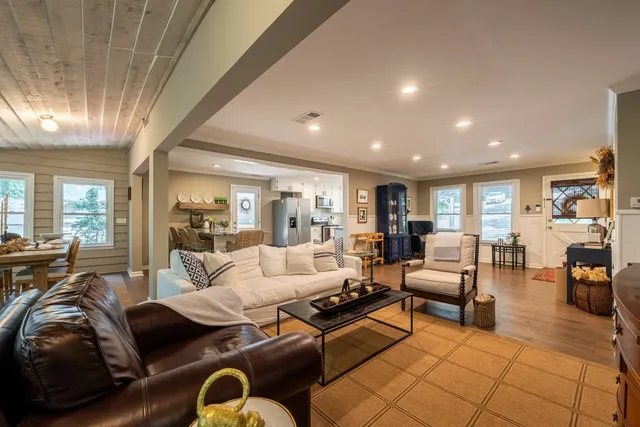 a dining room with furniture a large window and a rug