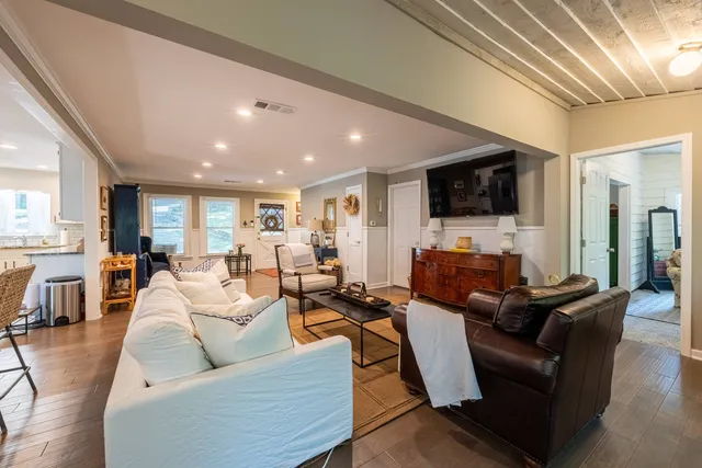 a kitchen with stainless steel appliances kitchen island granite countertop a refrigerator a stove and a sink with granite countertops