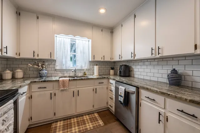 a view of a lake with lawn chairs