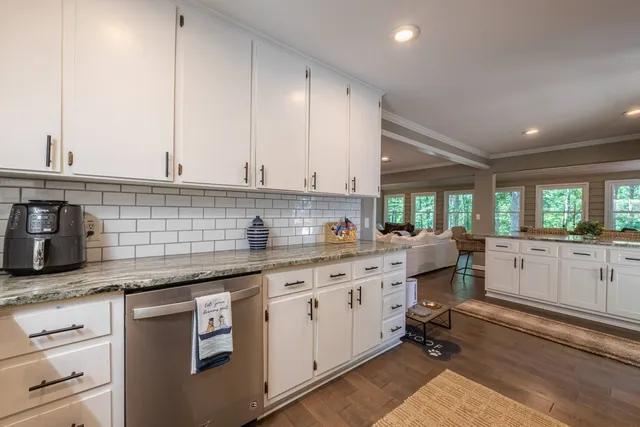 a patio with wooden floor a yard tables and chairs