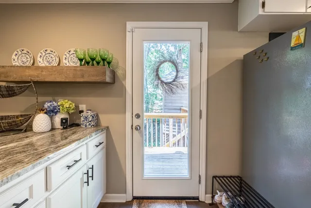 an aerial view of green landscape with trees and houses