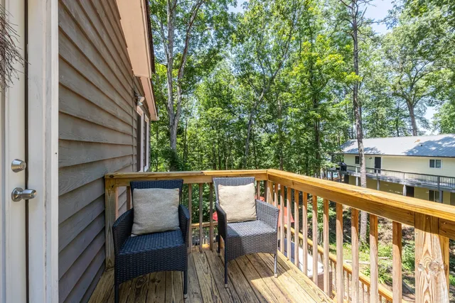 an aerial view of residential house with outdoor space and trees all around