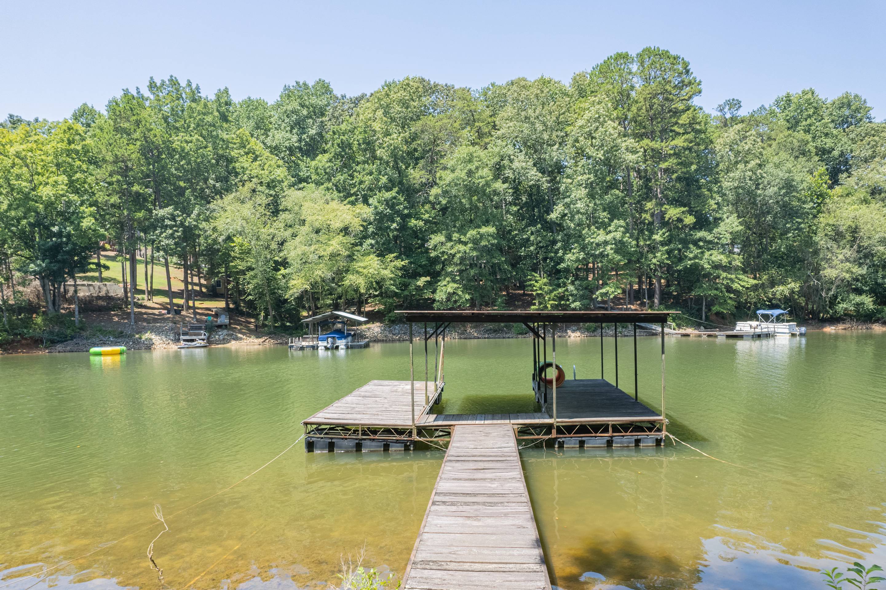 396 Cardinal Lane Toccoa, GA 30577 - Photo 80 of 103 a view of a lake with boats and trees in the background
