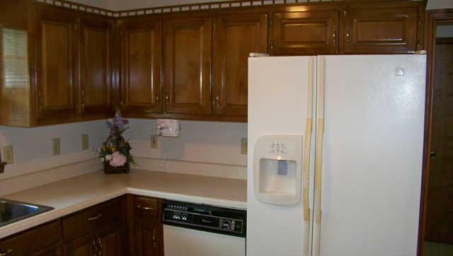 689 Ghea Road Normandy, TN 37360 - Photo 6 of 19 a kitchen with a refrigerator and cabinets