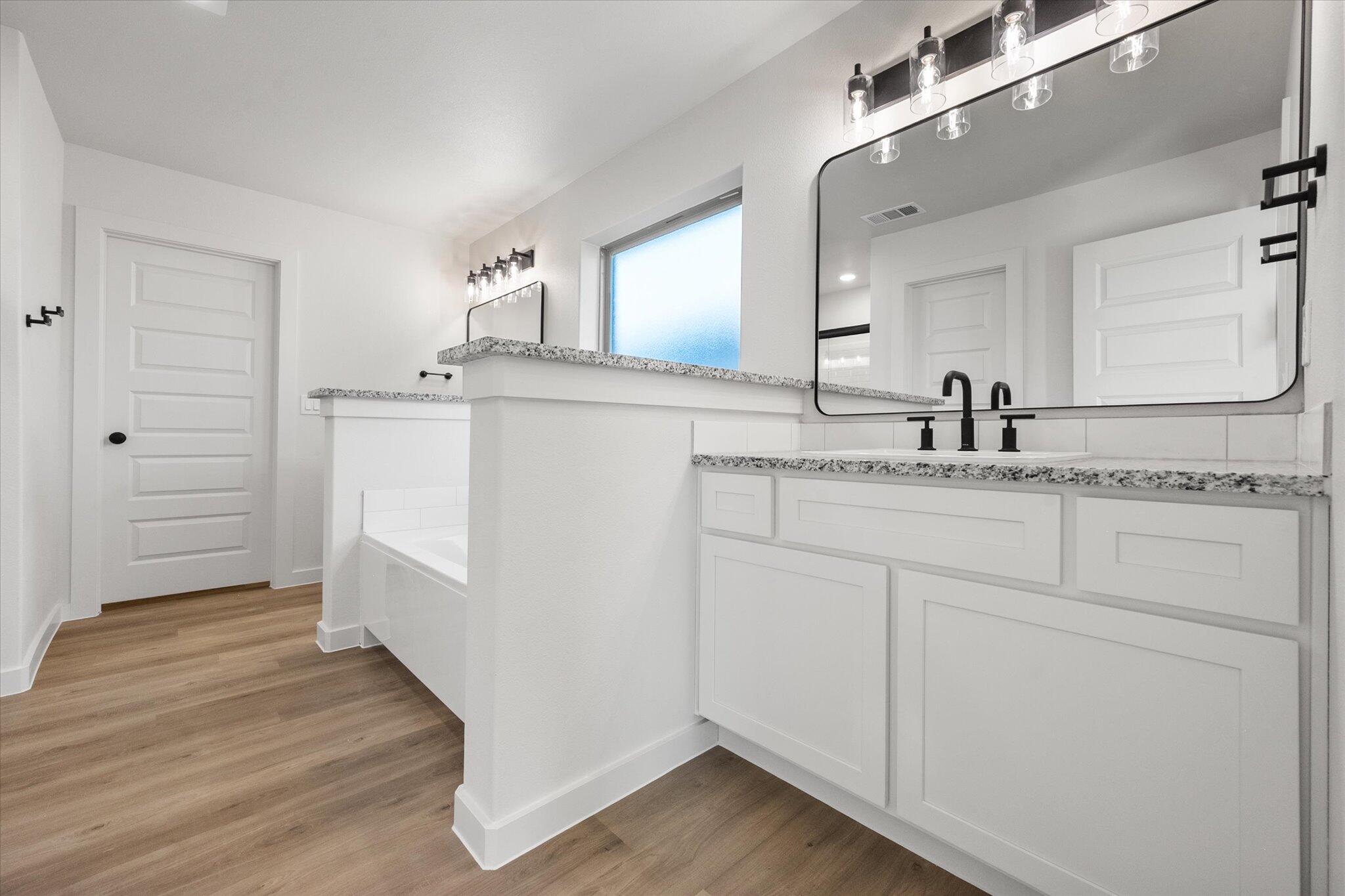 7007 56th Street Lubbock, TX 79407 - Photo 13 of 22 a bathroom with a sink and a mirror