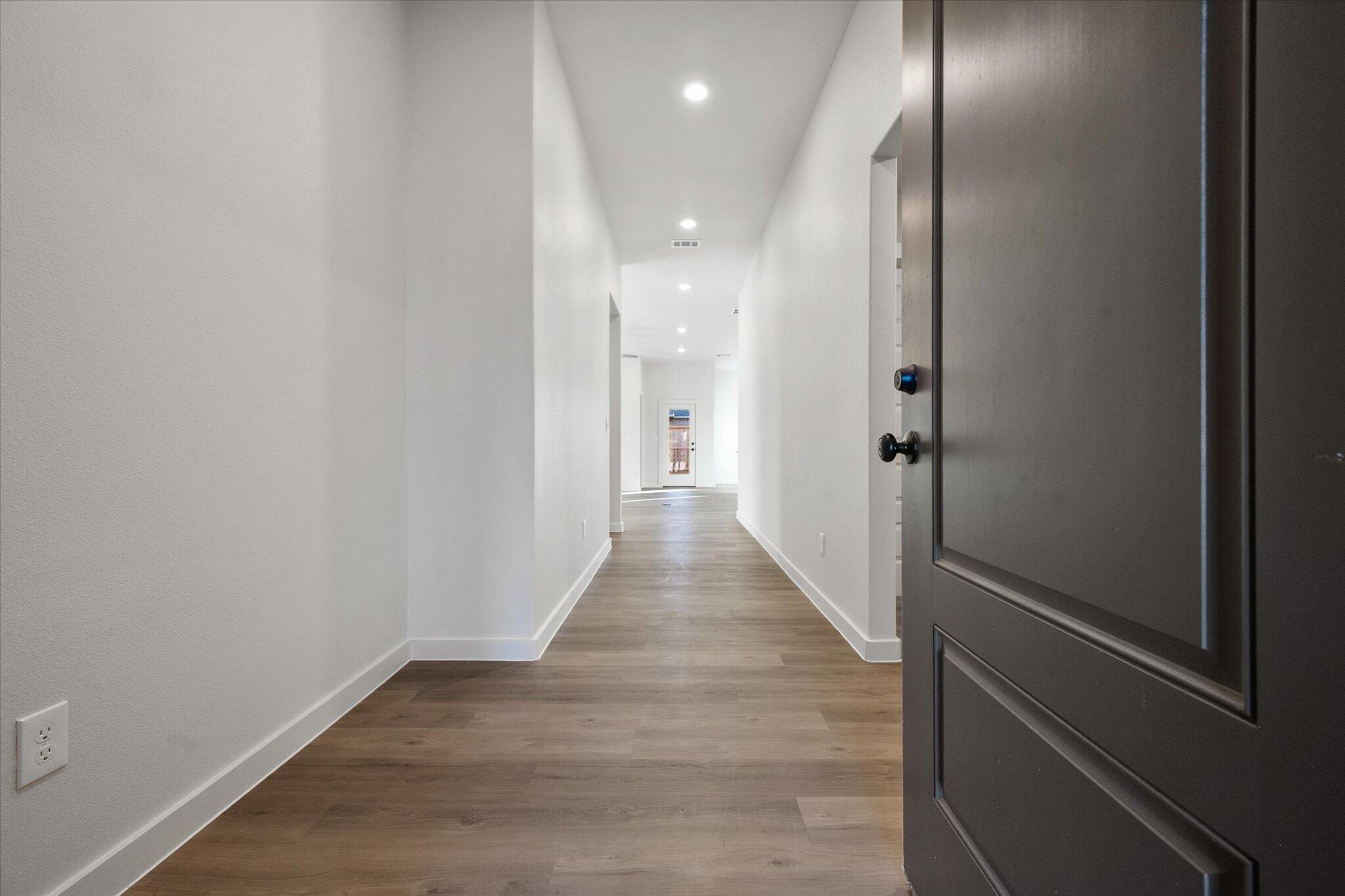 7007 56th Street Lubbock, TX 79407 - Photo 2 of 22 a view of a hallway with wooden floor