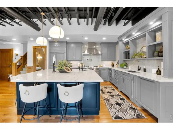 a kitchen with stainless steel appliances kitchen island granite countertop a sink and cabinets