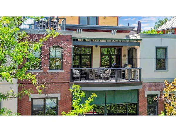 a picture of a building with a garden and plants