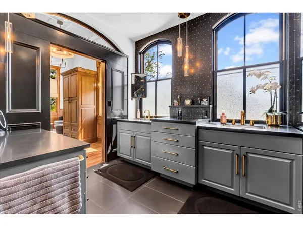 a kitchen with sink and large window
