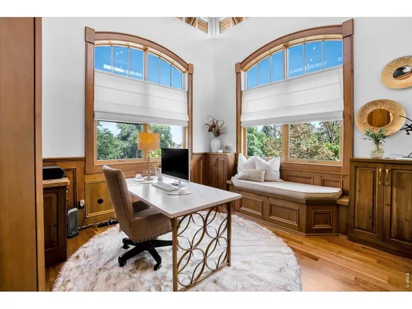 a dining room with furniture and wooden floor