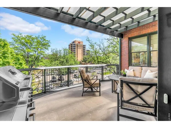 a view of a patio with a table and chairs