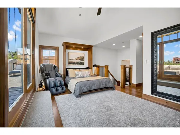 a spacious bedroom with a large bed and a large window