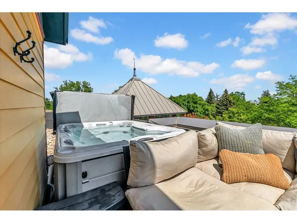 a balcony with furniture and potted plants