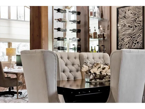 a view of a living room filled with furniture and a large window