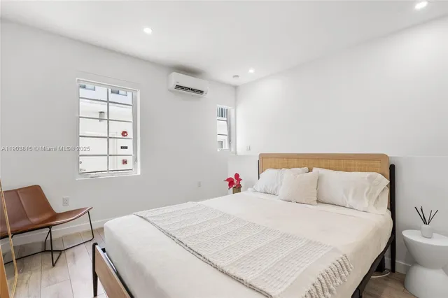 a bedroom with a large bed and a window