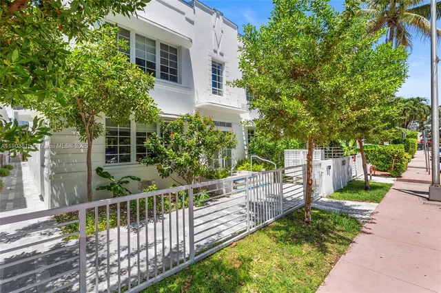 a view of a house with wooden fence
