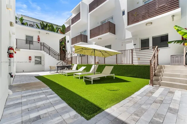 a view of a patio with a table and chairs