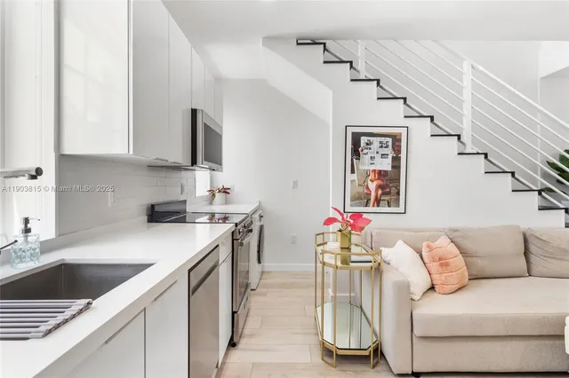 a kitchen with a sink cabinets and window