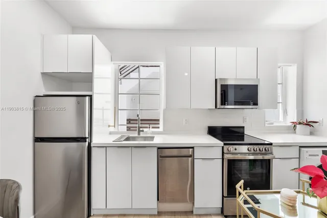 a kitchen with stainless steel appliances a refrigerator sink and microwave