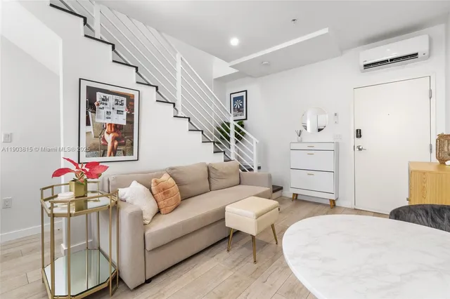 a living room with furniture and wooden floor