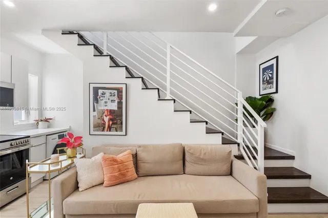 a living room with furniture and stairs