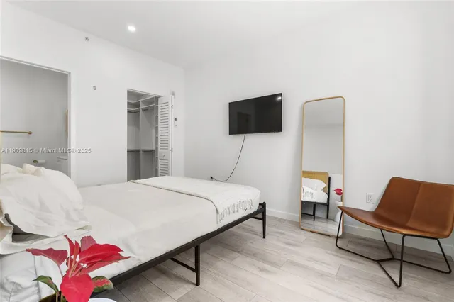 a bedroom with a bed and a chair