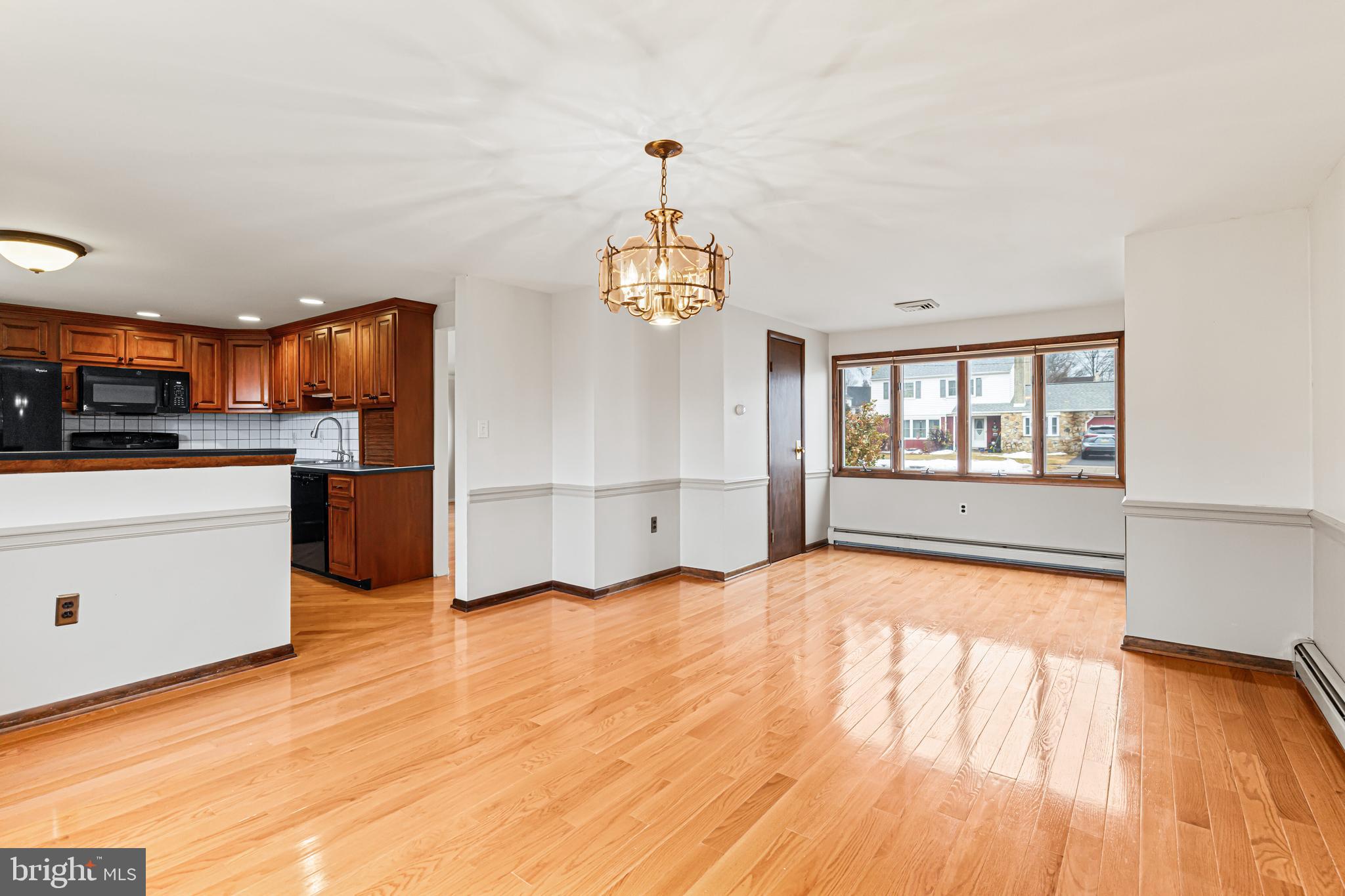 1413 Foster Road Warminster, PA 18974 - Photo 11 of 30 a view of a kitchen and an empty room with wooden floor windows