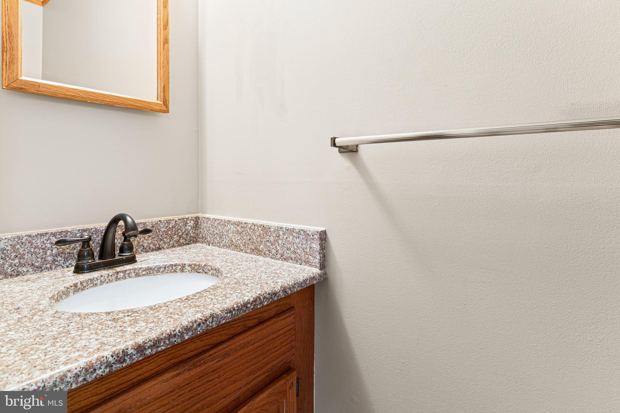 1413 Foster Road Warminster, PA 18974 - Photo 13 of 30 a bathroom with a granite countertop sink and a mirror
