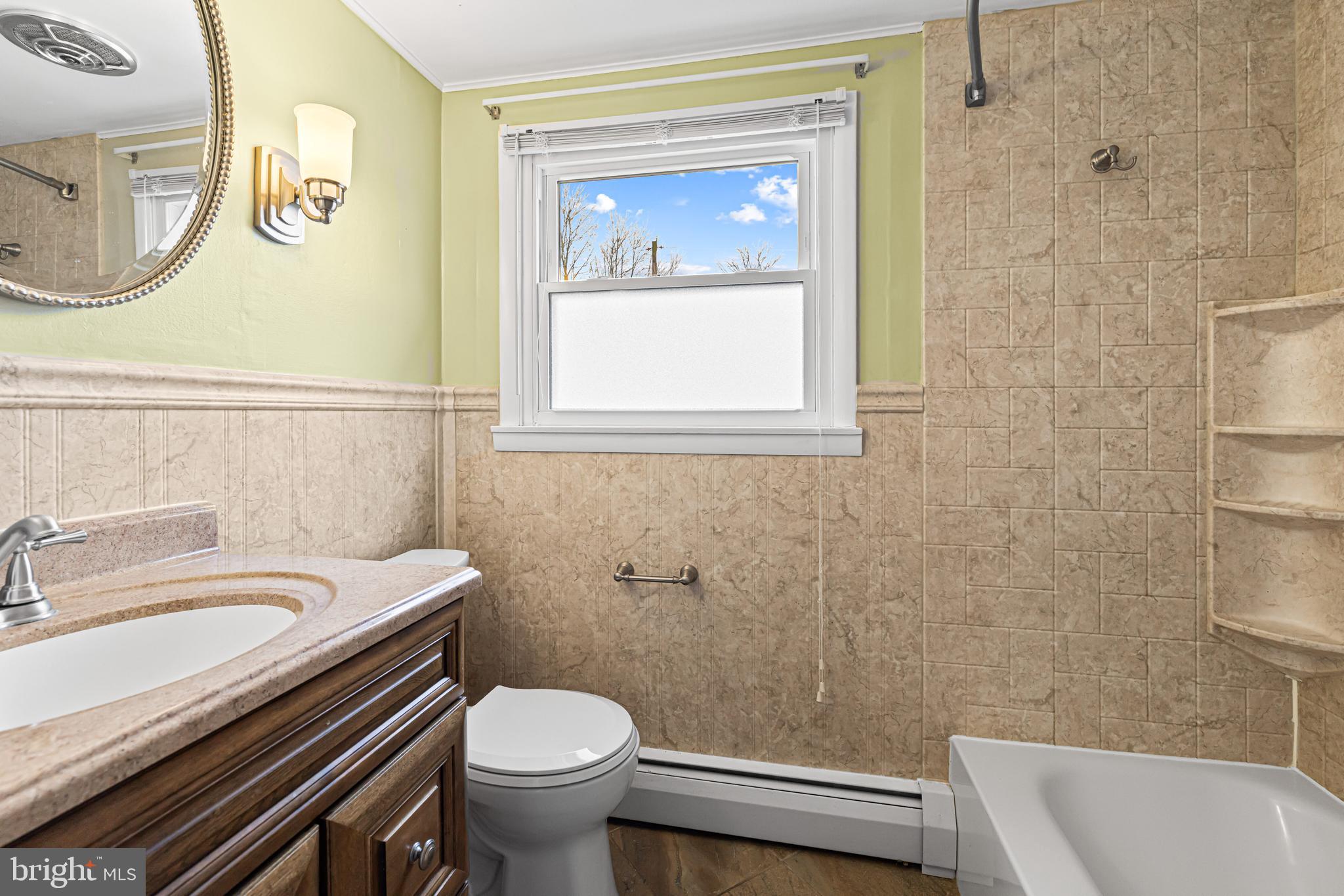 1413 Foster Road Warminster, PA 18974 - Photo 18 of 30 a bathroom with a sink a toilet and a mirror