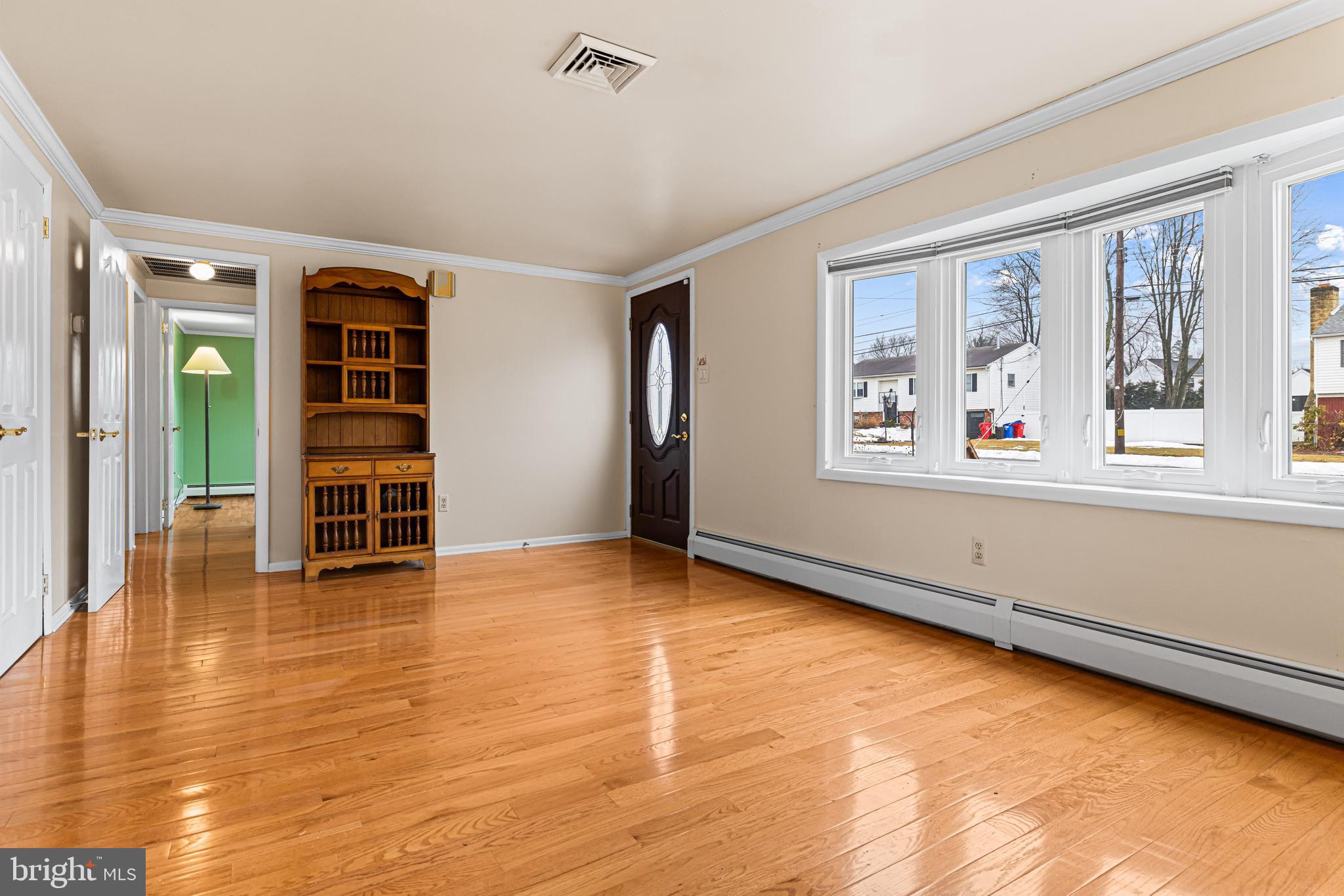 1413 Foster Road Warminster, PA 18974 - Photo 4 of 30 an empty room with wooden floor and windows