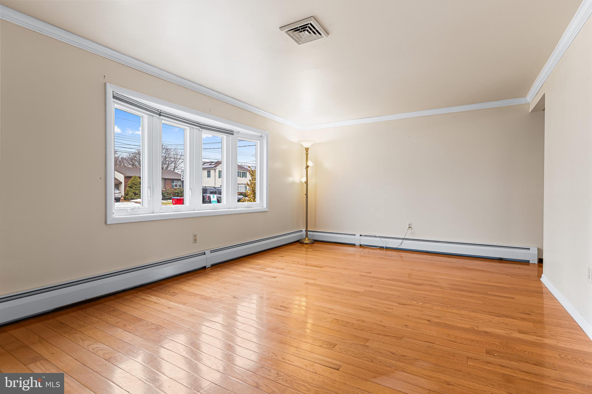 1413 Foster Road Warminster, PA 18974 - Photo 5 of 30 an empty room with wooden floor and windows