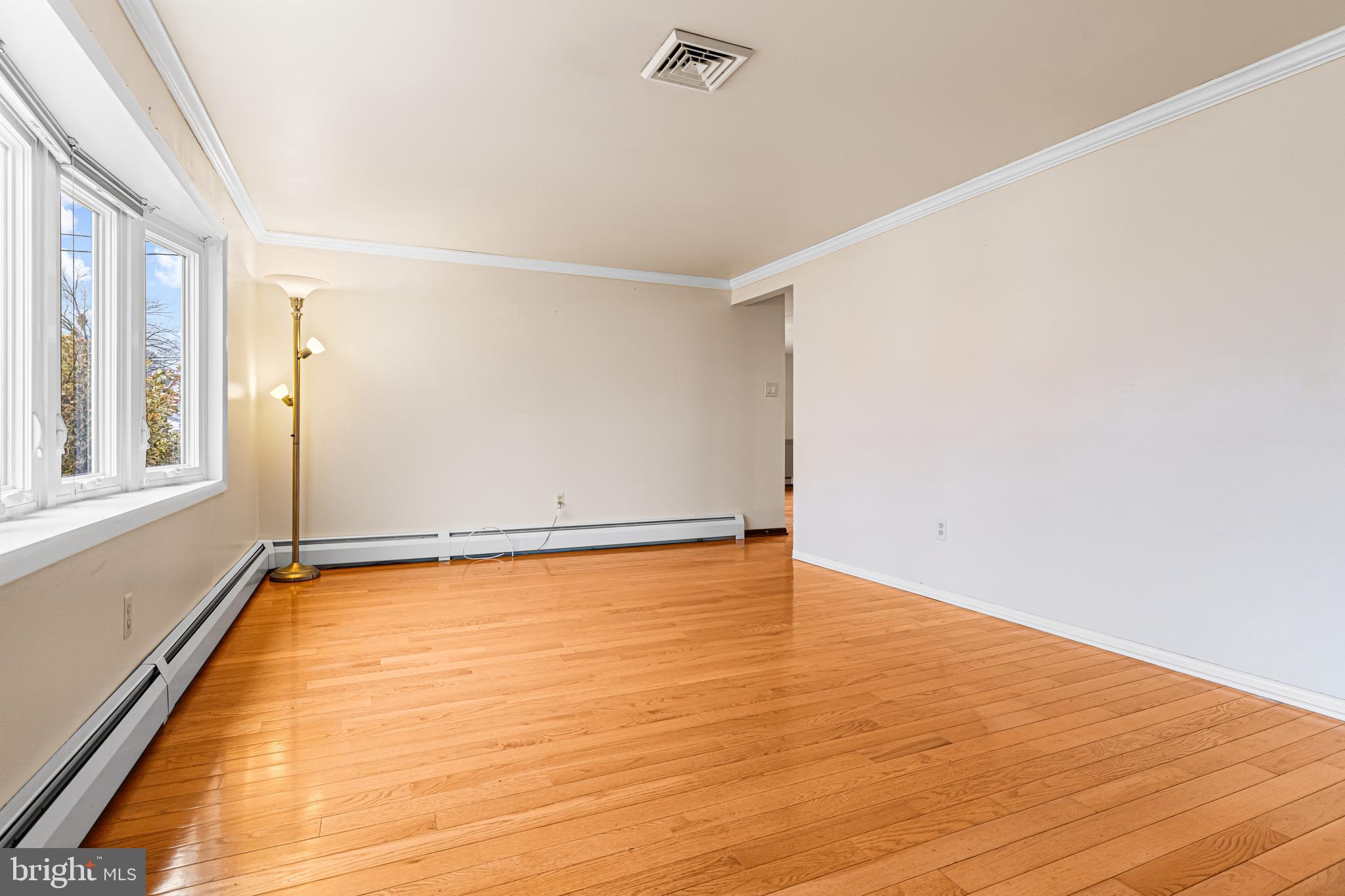 1413 Foster Road Warminster, PA 18974 - Photo 6 of 30 a view of an empty room with wooden floor and a window