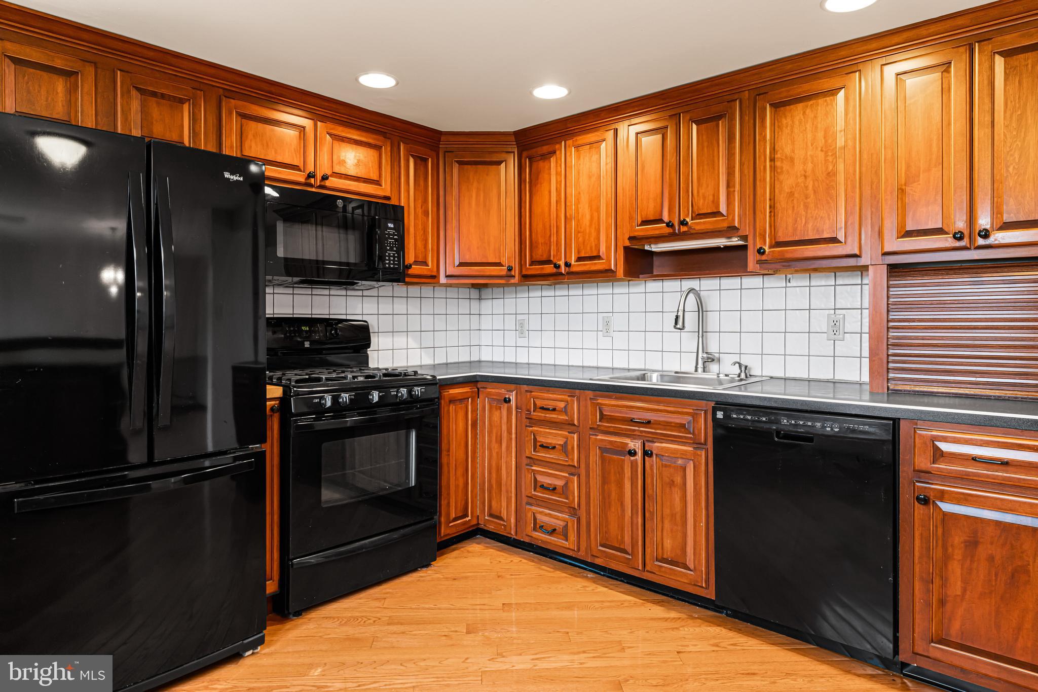 1413 Foster Road Warminster, PA 18974 - Photo 8 of 30 a kitchen with stainless steel appliances granite countertop a refrigerator a sink dishwasher a stove top oven and a kitchen island