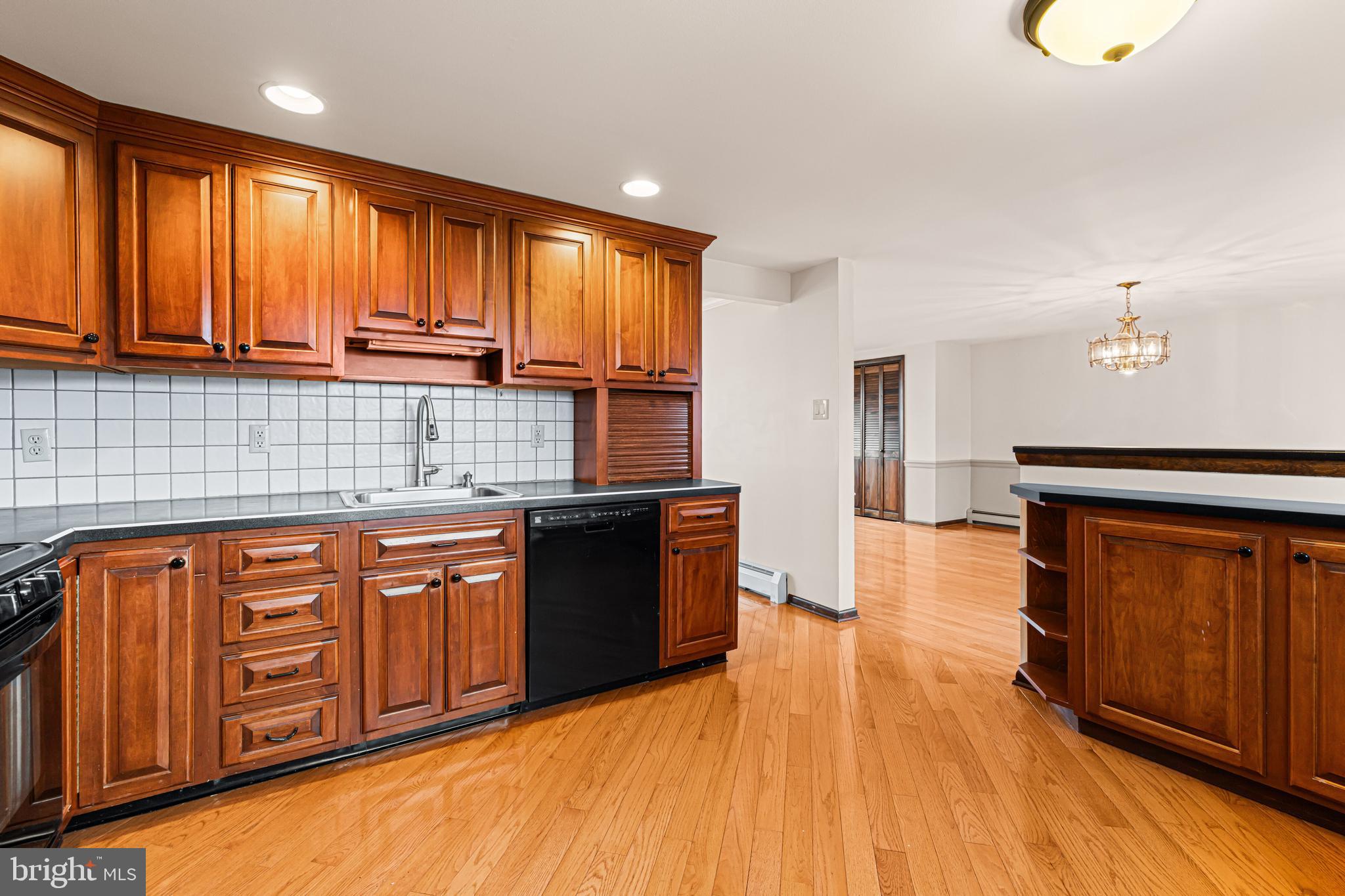 1413 Foster Road Warminster, PA 18974 - Photo 9 of 30 a large kitchen with stainless steel appliances granite countertop wooden cabinets a refrigerator and dishwasher with wooden floor