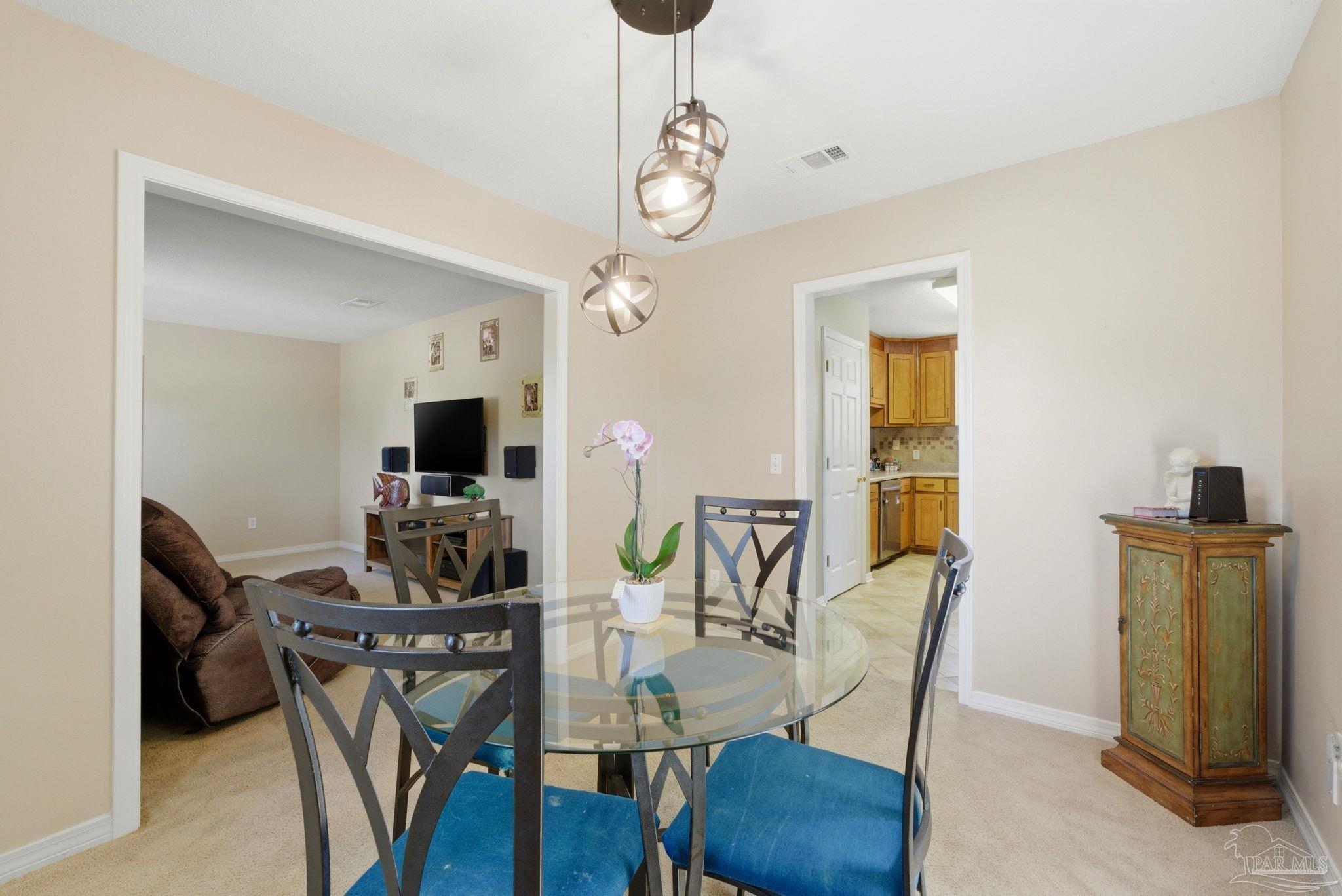 5121 Keyser Mill Road Baker, FL 32531 - Photo 7 of 52 a view of a dining room with furniture and wooden floor