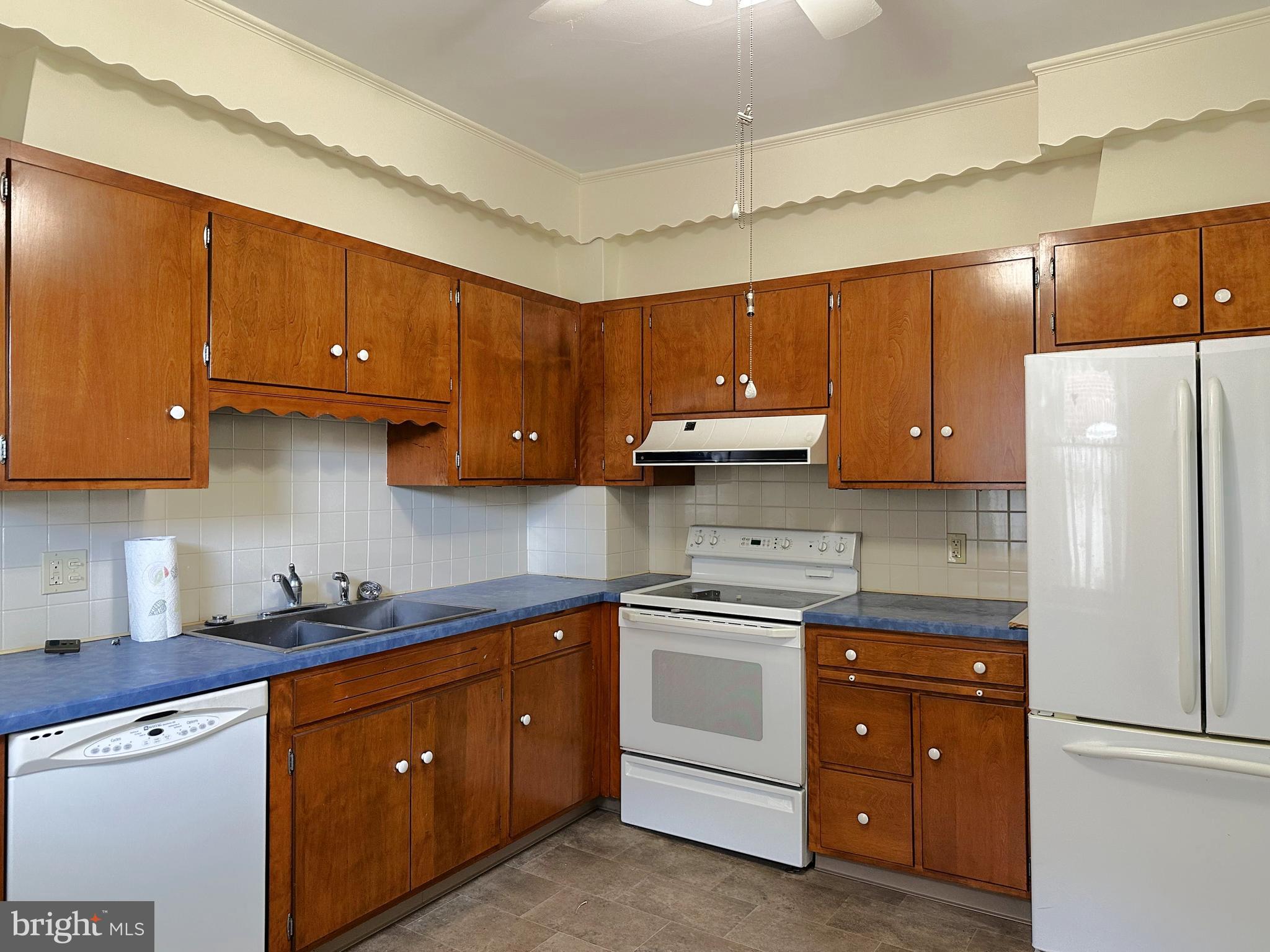 634 Main Street Red Hill, PA 18076 - Photo 12 of 34 a kitchen with a sink a refrigerator and cabinets
