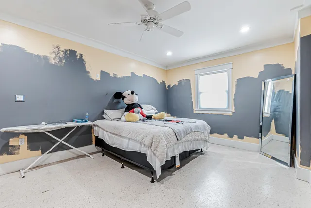 a bedroom with a bed and a chandelier