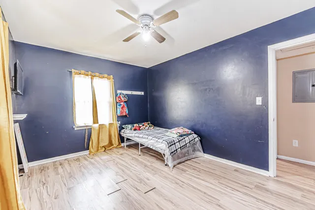 a bedroom with a bed and a chandelier
