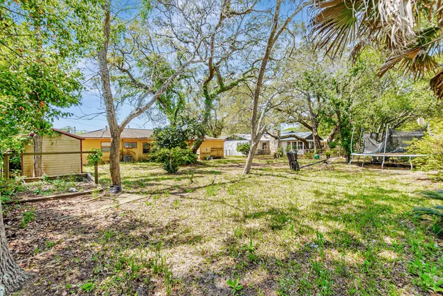 a backyard of apartments with large trees