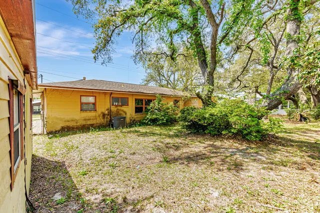 a view of a house with a tree in the background